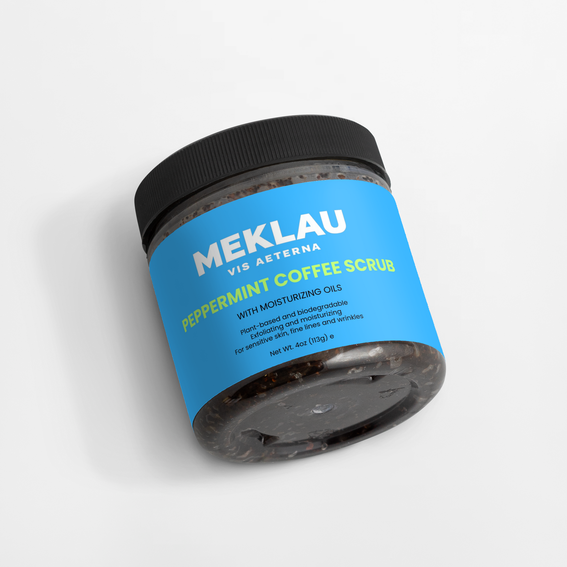 A jar of Meklau Vis Aterna Peppermint Coffee Scrub with a bright blue label and black lid, shown on a clean white background.