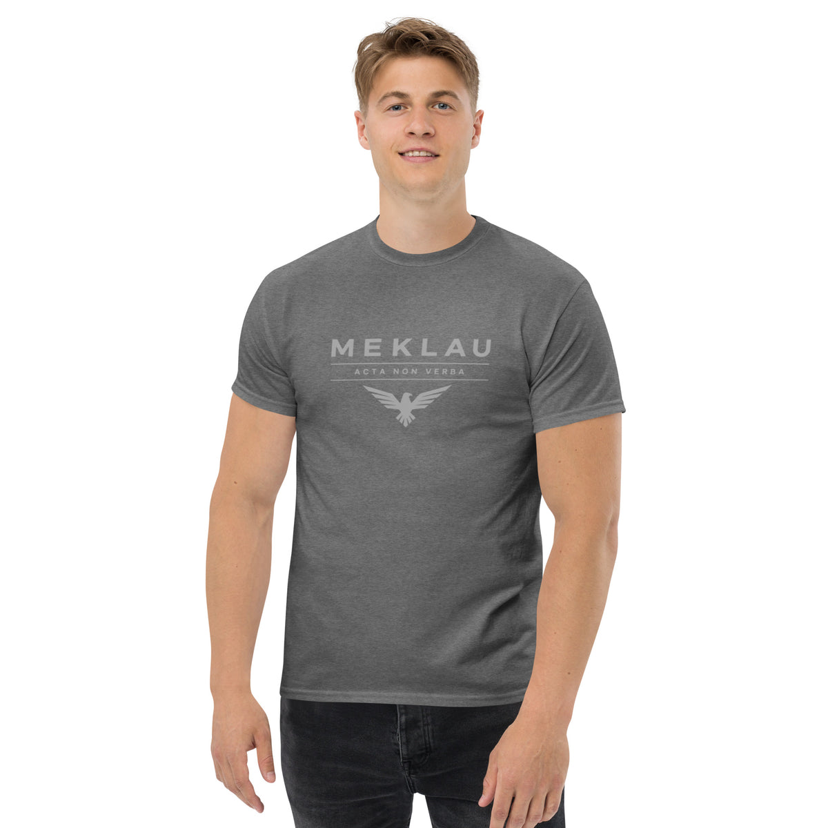 Man wearing a gray t-shirt with a sailboat design on a white background