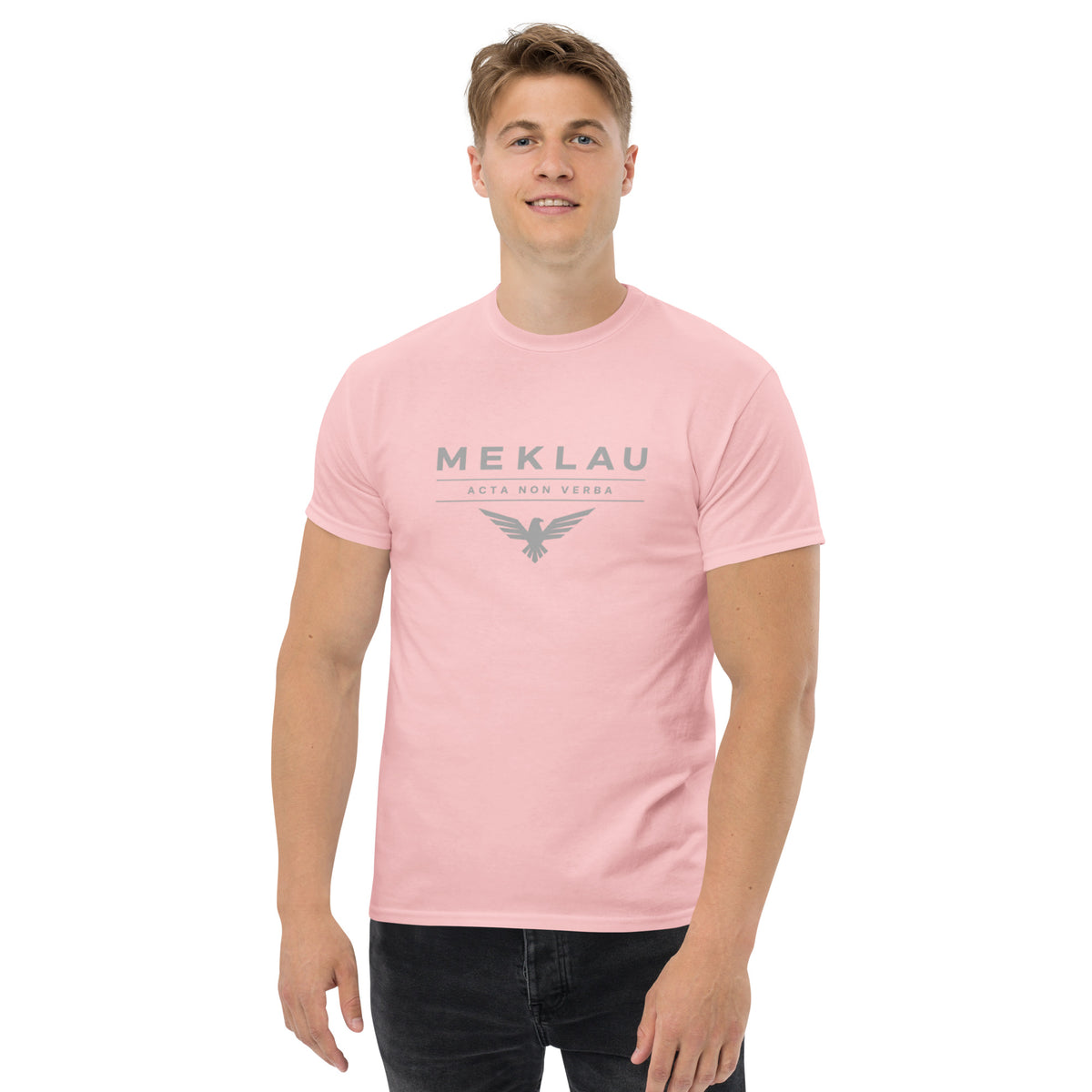 Person wearing a pink t-shirt with text on a white background