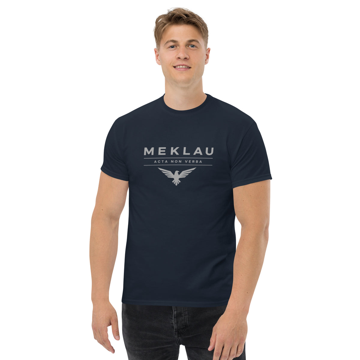 Man wearing a navy blue t-shirt with a graphic design on a white background